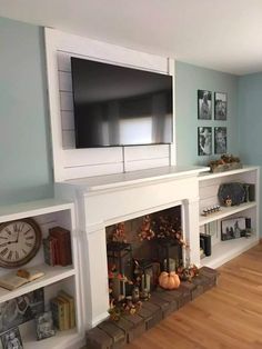 a living room filled with furniture and a flat screen tv mounted above a fire place