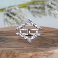 a diamond ring sitting on top of a wooden table