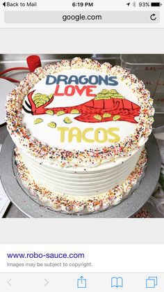 a cake that is sitting on top of a plate with sprinkles and the words dragon's love tacos