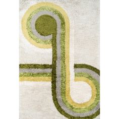 a white rug with green, yellow and grey designs on the bottom half of it