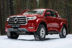 a red truck parked on top of a rocky beach