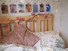 a bed with pillows and pictures on the wall