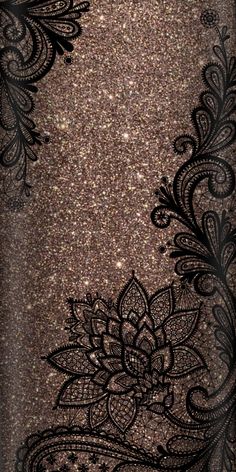 the back side of a cell phone case with black lace and flowers on gold glitter