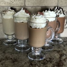 three glasses filled with hot chocolate and whipped cream