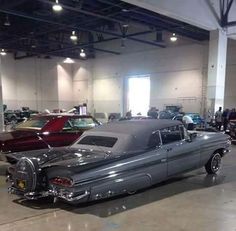 an old car is parked in a garage