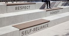 a person sitting on some concrete steps with their feet in the air and writing on them