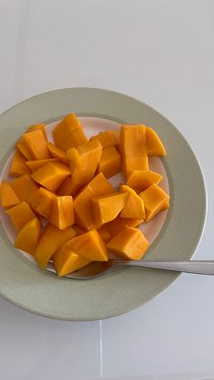 a white plate topped with cut up mangoes