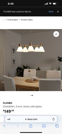 an image of a dining room table and chairs with lights on the wall above it