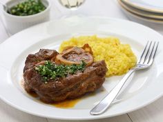 a white plate topped with meat and vegetables