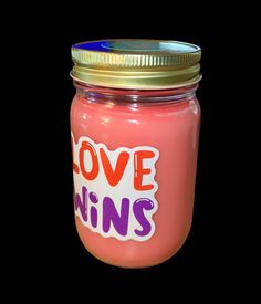 a pink jar with the words love wins on it