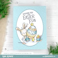 a card with an easter bunny holding a cupcake and the words wishing you easter fun on it