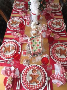 a table set for christmas with gingerbread cookies