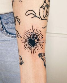 a person with a heart tattoo on their arm