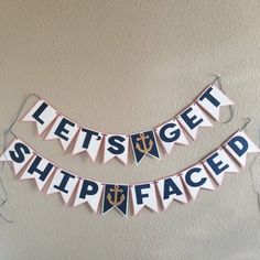 two pennants that say let's get shipfaced and an anchor on them