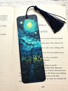 a bookmark with an image of a starry night on it and a tassel