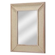 a mirror that is on the wall with a white frame and light wood trimming