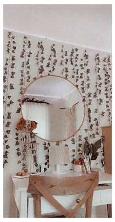 a mirror sitting on top of a wooden table next to a white desk and chair