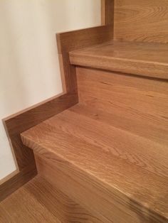 wooden steps leading up to a white wall