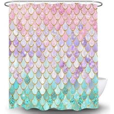 a shower curtain with pink, blue and green mermaid scales on the outside of it