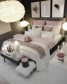 a white and black bedroom with pink accents