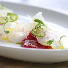 a white plate topped with food on top of a wooden table