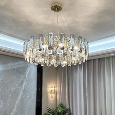 a chandelier hanging from the ceiling in a living room