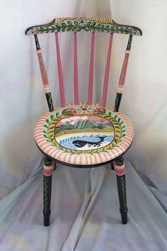 a wooden chair with an animal painted on it