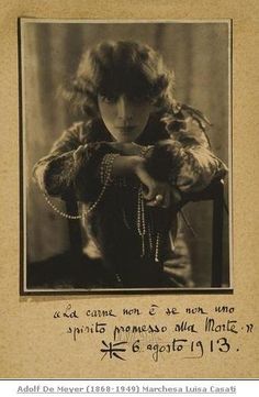 an old black and white photo of a woman with pearls on her head, wearing a fur coat