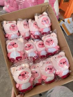 a box filled with lots of pink pigs