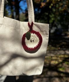 a white bag with an apple on it