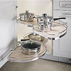 a kitchen with pots and pans sitting on the shelves in front of the stove