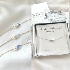 a box with some pearls and a necklace in it