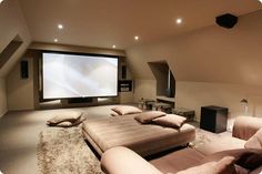 a large room with couches and a flat screen tv on the wall in it