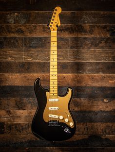 an electric guitar sitting on top of a wooden floor