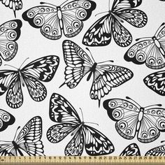 black and white butterflies with swirls on them, in the shape of a square frame