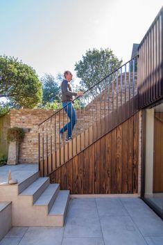 a man is walking up the stairs on his skateboard