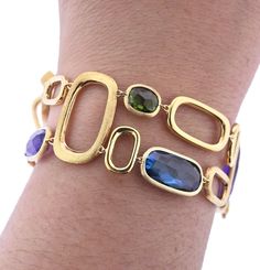 Marco Bicego Murano collection 18K yellow gold link bracelet, set with amethyst, citrine, peridot, topaz, tourmaline gemstones. DESIGNER: Marco Bicego MATERIAL: 18K Yellow Gold GEMSTONE: Spessartite garnet, Amethyst, Topaz, Peridot, Citrine CLARITY/COLOR: n/a MEASUREMENTS: Bracelet is 7" long x 1" wide MARKED/TESTED: Marco Bicego Made in Italy; Italian mark, 750 WEIGHT: 27.0 grams CONDITION: New PRODUCT ID: OG-1033 Bracelets With Gemstones, Modern Gold Multi-stone Gemstones, Modern Gold Bracelet With Multi-stone, Modern Gold Multi-stone Jewelry, Italian Gold Jewellery Design, Dimond Breslet, Marco Bicego Jewelry, Italian Gold Jewelry, Diamond Bracelet Design