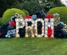 a large sign that says mom surrounded by balloons and lights in the shape of letters