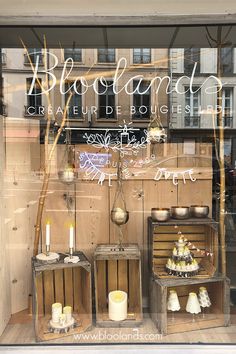 a store window with wooden crates and candles