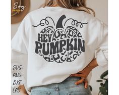 a woman wearing a white sweatshirt with the words hey, you're pumpkin printed on it