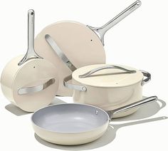 an assortment of cookware is shown on a white background with one pan and two frying pans