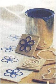 some crafting supplies are laying out on a white tablecloth with blue and gold designs