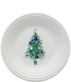 a white bowl with a christmas tree painted on the side in blue, yellow and green