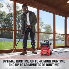 a man is using a vacuum to clean the floor