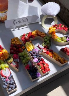 a table topped with lots of different types of fruits and veggie trays