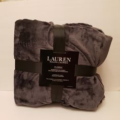 the luxury blanket is made from gray and black material with a black ribbon around it