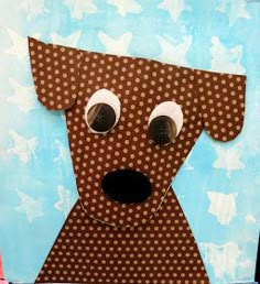 a dog made out of brown paper with polka dots on it's face and nose