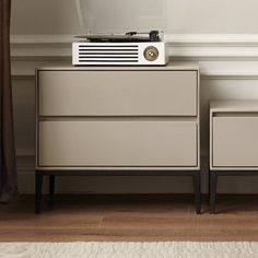 an old record player sitting on top of a dresser