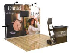 an exhibit stand with a clock on it and a sign that says, daniel wellington