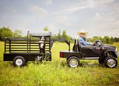 a little boy riding in the back of a truck with a dog